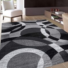 a living room area with a large rug on the floor