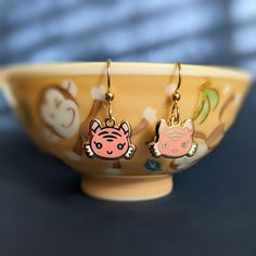 I designed these kawaii-tiger enamel earrings especially for 2022, the year of the tiger! Coincidentally, they're 22k-gold-plated, so that's fun! ♡ They also feature elegant, high-quality gold-filled ear wires (with or without bead details, your choice), which keep the overall aesthetic very refined. And I performed final assembly of every earring myself, so that I could be a control-freak about quality and comfort. The charms are extra petite so that they're extra cute! (Specs below.) I love th Cute Specs, Kawaii Tiger, Tiger Earrings, Pastel Earrings, Extra Petite, Kawaii Earrings, Year Of The Tiger, Paper Jewelry, Enamel Earrings