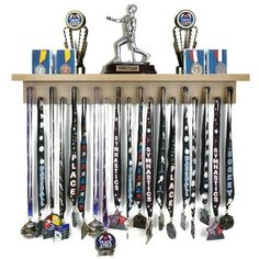 a wooden shelf with trophies and medals hanging from it's sides in front of a white background