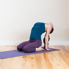 a woman is doing yoga on a purple mat