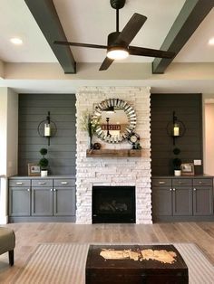 a living room with a fire place and ceiling fan in the middle of the room