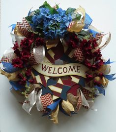 a welcome wreath with blue and red flowers