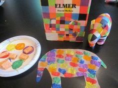 a paper plate with an elephant next to it and a box of erasers on the table