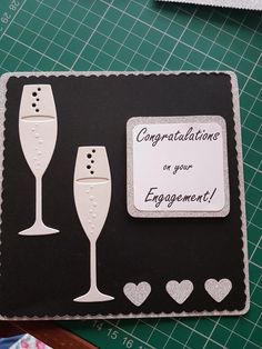 congratulations on your engagement card with two champagne glasses and hearts in the shape of hearts