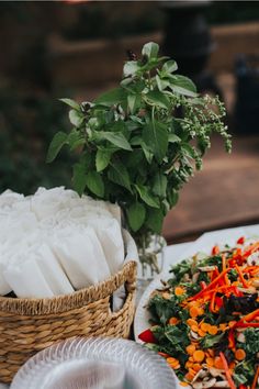 a table topped with plates and baskets filled with food