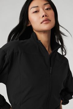 Sporty, streamlined and oh-so cool, the Clubhouse Jacket is crafted from a sleek, slightly swishy fabric with a little stretch. It has a stand collar, full front zipper, vented back and waist-grazing cropped hem. And it’s so easy to style—try it with your performance favorites like leggings and a bra, or with more polished pieces like trousers and a white tee. Womens Onesie, Tank Top Long Sleeve, Tank Top Bras, Womens Capris, Back Women, Bra Women, Light Jacket, Yoga Wear, Crop Tops Women