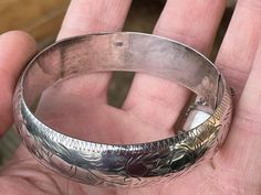 Here we have a 925 solid silver engraved bangle/bracelet 6cm internal diameter Stamped 925 on the clip and inside the bangle face -16grams Opening clip works well and has a safety chain which is intact  A few small dints on the bangle face that you can see clearly on the images Please visit https://antiqueforager.com/collections for more options Please note all our items are second hand, vintage or antiques; they are in good condition but may show signs of use. Please make sure to favourite our Silver Engraved Round Bangle, Silver Stamped Round Cuff Bracelet, Sterling Silver Round Stamped Bracelet, Engraved Bangle Bracelet, Engraved Bangle, Safety Chain, Porcelain Ceramics, Ceramic Sculpture, Bangle Bracelet