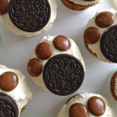 cupcakes decorated with oreo cookies and white frosting