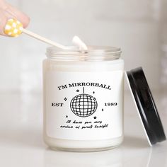 a person holding a toothbrush in a jar with the word i'm mirrorball on it