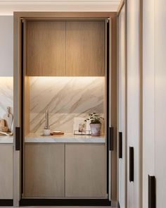 a kitchen with wooden cabinets and marble counter tops