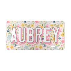 a license plate with flowers and the word aubrey in pink, white, and blue