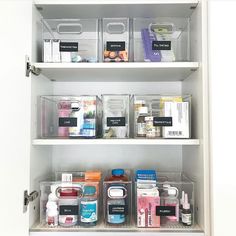 an organized pantry with clear bins and plastic containers