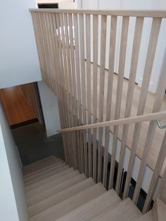 there is a wooden hand rail on the stairs