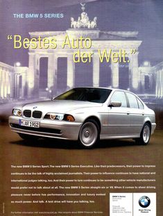 an advertisement for the bmw 5 series shows a silver car in front of a building