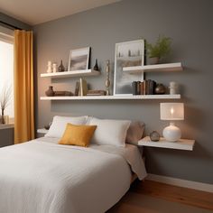 a white bed sitting in a bedroom next to a window with yellow drapes on the windowsill