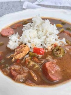 a white plate topped with soup and rice