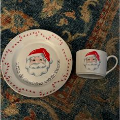 two christmas themed plates with santa's faces on them, one is white and the other is red