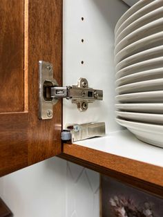 a close up of a cabinet door with plates on it