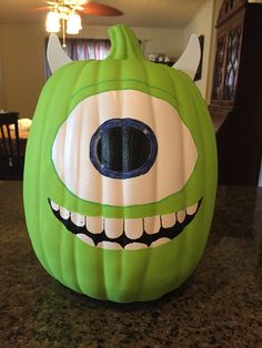 a green monster pumpkin sitting on top of a counter