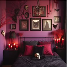 a bedroom decorated for halloween with candles and pictures on the wall