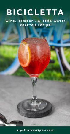 a glass filled with a drink sitting on top of a table