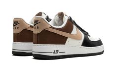 The Nike Air Force 1 Low “Mocha” is a colorway of the retro basketball shoe with the coffee-inspired shade of brown on its design.  The Air Force 1 Low “Mocha” is complete with Summit White leather on the perforated toe and mid-panel, and Black leather on the toe cap, forefoot, and eyelets.  A coffee-inspired shade of Mocha leather can be seen on the quarter panel and heel.  A tan suede Swoosh appears on either side of the shoe, and classic “Nike Air” and “Nike Air Force 1” branding are located