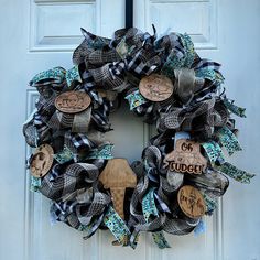 a black and white wreath with wooden signs on it