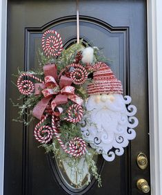 a christmas wreath with santa clause and candy canes hanging on the front door to say who's getting country down the days?