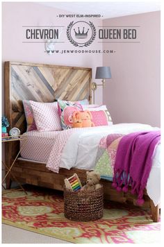 a bedroom with pink walls and wooden headboard