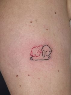 a small sheep tattoo on the stomach