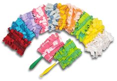 multicolored pieces of paper laid out on top of each other with toothbrushes next to them