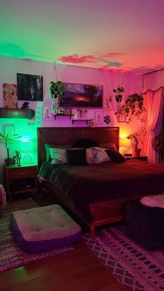 a bed room with a neatly made bed and colorful lights