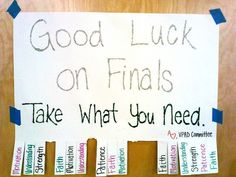 a sign that says good luck on finalss take what you need with some stickers attached to it