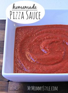 homemade pizza sauce in a square white bowl on a wooden table with the words homemade pizza sauce above it