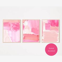 three pink and white paintings on a wall