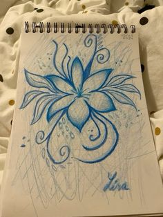 a drawing of a blue flower on top of a sheet of paper