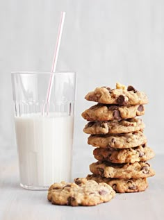 a stack of cookies next to a glass of milk