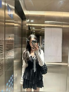 a woman taking a selfie in an elevator