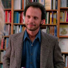 a man standing in front of a bookshelf