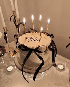 a birthday cake with lit candles on it