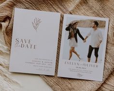 two save the dates cards sitting on top of a blanket