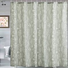 a shower curtain with white flowers on it