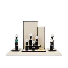 an assortment of black and white objects sitting on top of a table next to a mirror