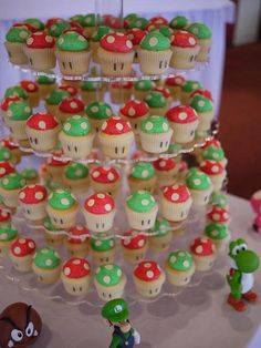 cupcakes are arranged in the shape of trees and mushroomes on a table