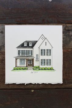 a drawing of a house on top of a wooden table