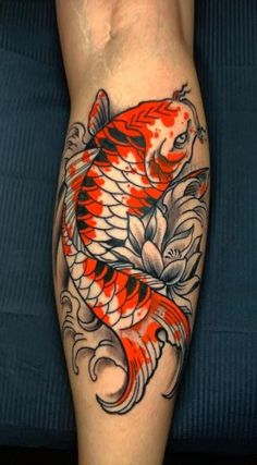 a person with a tattoo on their leg and a koi fish in the middle