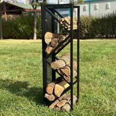 a stack of logs sitting on top of a grass covered field