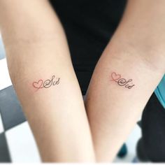 two people with matching tattoos on their arms that say she and she are holding each other's hands