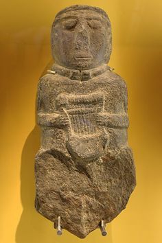 an ancient statue is on display in a museum