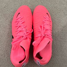 a pair of pink nike shoes on the floor